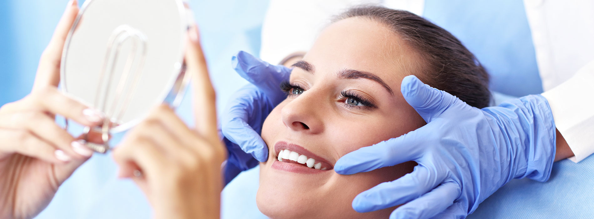 A woman receiving a facial treatment with a professional in a medical setting.